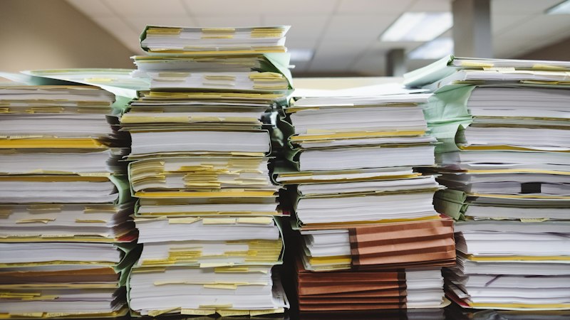 Stacks of documents and files from a claim