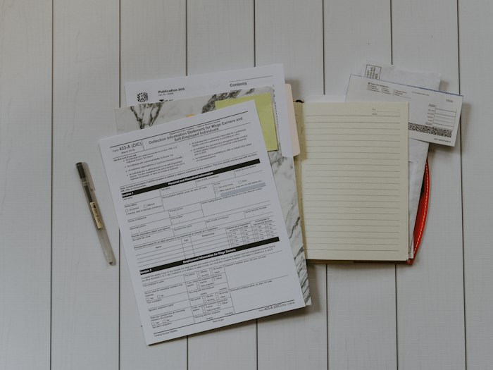 Employment paperwork laid out on a table to review a final settlement